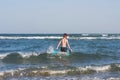 Teen boy in the swim flippers snorkeling mask and tude in the sea wave