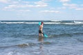 Teen boy in the swim flippers snorkeling mask and tude in the sea wave