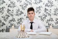 teen boy at table with cake for his fourteenth birthday