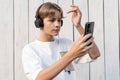 teen boy taking selfie on a white wooden background outdoor, sharing in social media, teen lifestyle, blogging, teenager