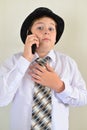 Teen boy talking on cell phone at light background Royalty Free Stock Photo