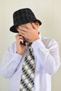 Teen boy talking on cell phone at light background Royalty Free Stock Photo