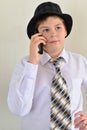 Teen boy talking on cell phone at light background Royalty Free Stock Photo
