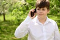 Teen boy talking on phone outdoors Royalty Free Stock Photo