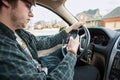 Teen boy texting and driving dangerous distracted Royalty Free Stock Photo