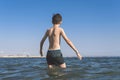 Teen boy in the wave of sea in the tropical resorts. Concept