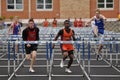 Teen Boys Competing in High School Hurdles Race Royalty Free Stock Photo