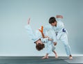The two boys fighting at Aikido training in martial arts school. Healthy lifestyle and sports concept Royalty Free Stock Photo