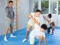 Teen boys practicing armlock in training bout during self defence course