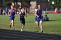 Teen Boys Running in Long Distance Track Meet Race