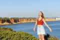 Teen breathing fresh air in the coast