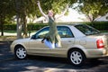 Teen With Car Jumps for Joy Royalty Free Stock Photo