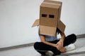 Teen with carton head mask