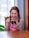 Teen cheers on her friends as she watches her cell phone