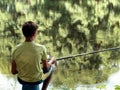 Teen child catches a fishing rod on the pond