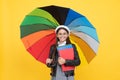 teen child under colorful parasol. kid in beret with rainbow umbrella. autumn season. Royalty Free Stock Photo