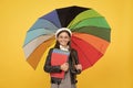 teen child under colorful parasol. kid in beret with rainbow umbrella. autumn season. Royalty Free Stock Photo