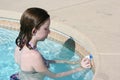 Teen cleaning pool edge