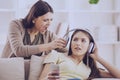 Teen closed ears with headphone while mom yells Royalty Free Stock Photo