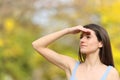 Teen contemplating protecting from sun in a park Royalty Free Stock Photo