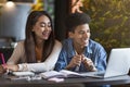 Teen couple of students enjoying studying at cafe Royalty Free Stock Photo