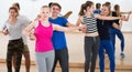 Teen couples having dancing class indoors Royalty Free Stock Photo