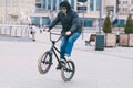 Teen does tricks on the BMX. BMX cyclist rides a bike around the park and makes tricks. BMX concept