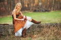 Teen in dress with cowboy boots Royalty Free Stock Photo