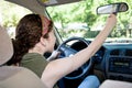 Teen Driver Adjusting Rearview Mirror