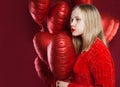 Teen girl with balloons red heart on red background Royalty Free Stock Photo