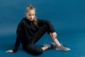 Teen girl in black hoodie sitting on floor Royalty Free Stock Photo