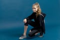 Teen girl in black hoodie sitting on floor Royalty Free Stock Photo