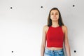 Teen girl blowing a chewing gum bubble against a concrete wall Royalty Free Stock Photo