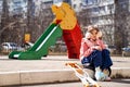 teen girl with a broken leg on crutches in the playground. Royalty Free Stock Photo