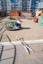 teen girl with a broken leg on crutches sits on a carousel in the playground. Royalty Free Stock Photo