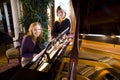 Teen girl with brother by piano Royalty Free Stock Photo