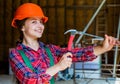 teen girl builder in protective helmet use hammer, repair