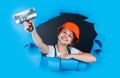 teen girl builder in protective helmet use spatula, building