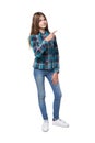 Teen girl in checkered shirt standing casually