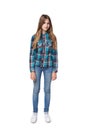 Teen girl in checkered shirt standing casually