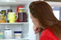 Teen girl checking out the fridge