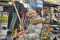 teen girl chooses a bow for shooting sports shop