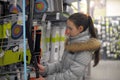 Teen girl chooses a bow for shooting sports shop