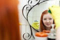 Teen girl cleans mirror in bathroom Royalty Free Stock Photo