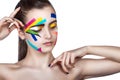 Teen girl with colored stripes on the face. Bright make-up art. Royalty Free Stock Photo