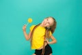 The teen girl with colorful lollipop on a blue background Royalty Free Stock Photo