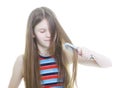 Teen girl combing her long hair