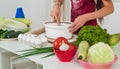 teen girl in cook uniform prepare food in kitchen, vegetarian