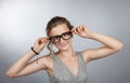 Teen girl corrects glasses Royalty Free Stock Photo