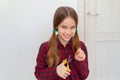 Teen girl cutting hair to herself with scissors Royalty Free Stock Photo